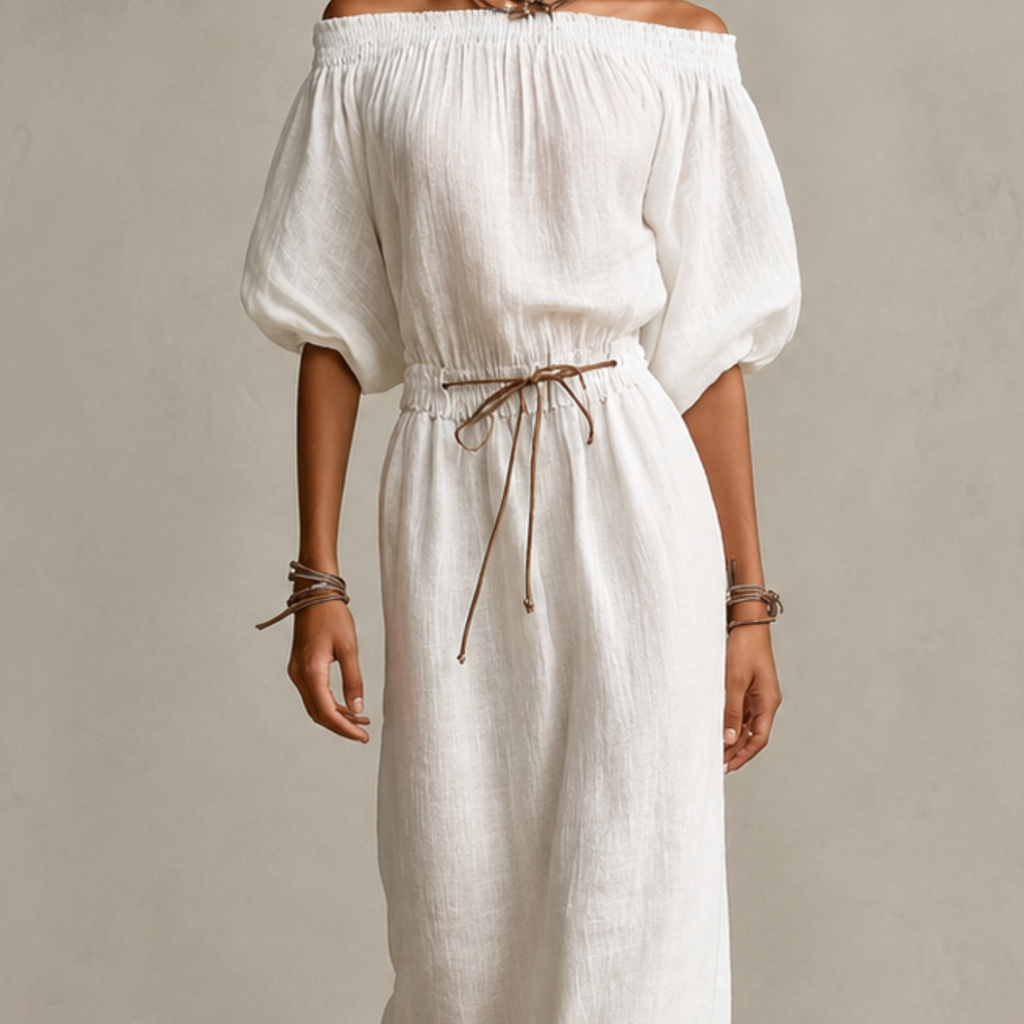 Close-up detail of the Noa Off-Shoulder Lightweight Linen Maxi Dress in white highlighting the off-shoulder neckline, lightweight linen texture, lantern sleeves, and adjustable waist tie. Designed by Bella Hudson.
