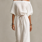 Close-up detail of the Noa Off-Shoulder Lightweight Linen Maxi Dress in white highlighting the off-shoulder neckline, lightweight linen texture, lantern sleeves, and adjustable waist tie. Designed by Bella Hudson.