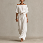 Noa Off-Shoulder Lightweight Linen Maxi Dress in white featuring an off-shoulder neckline, lantern sleeves, adjustable waist tie, and flowing maxi-length silhouette. Designed by Bella Hudson.