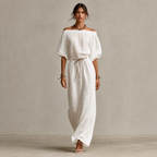 Full model view of the Noa Off-Shoulder Lightweight Linen Maxi Dress in white featuring an off-shoulder neckline, lantern sleeves, adjustable waist tie, and relaxed maxi-length silhouette. Designed by Bella Hudson.