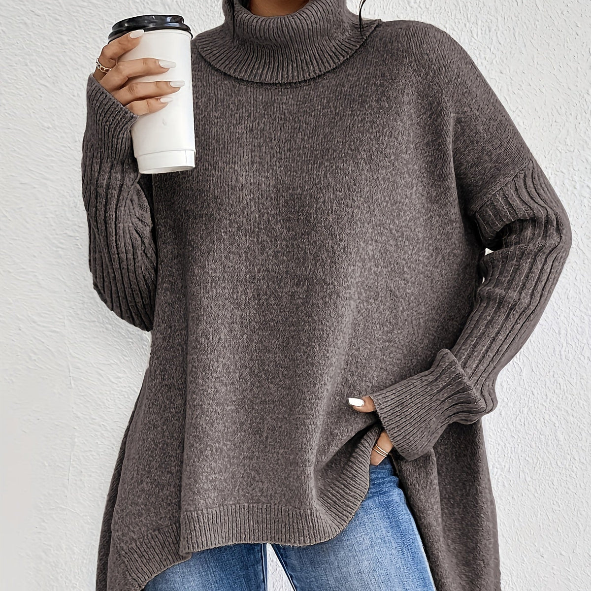 Noelle Brown oversized high-neck sweater featuring wide batwing sleeves, ribbed cuffs, side openings, and a relaxed fit