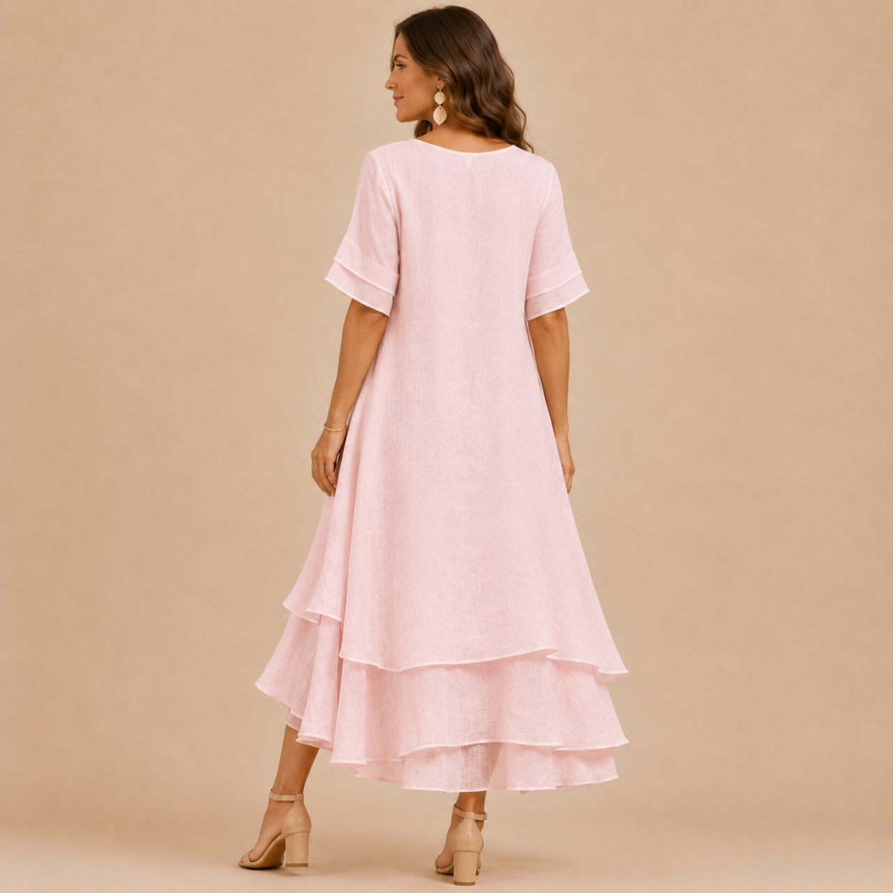 Noor Floral-Print Round-Neck Linen Midi Dress in Pink, back view showcasing the flowing layered design and relaxed fit. Designed by Bella Hudson.
