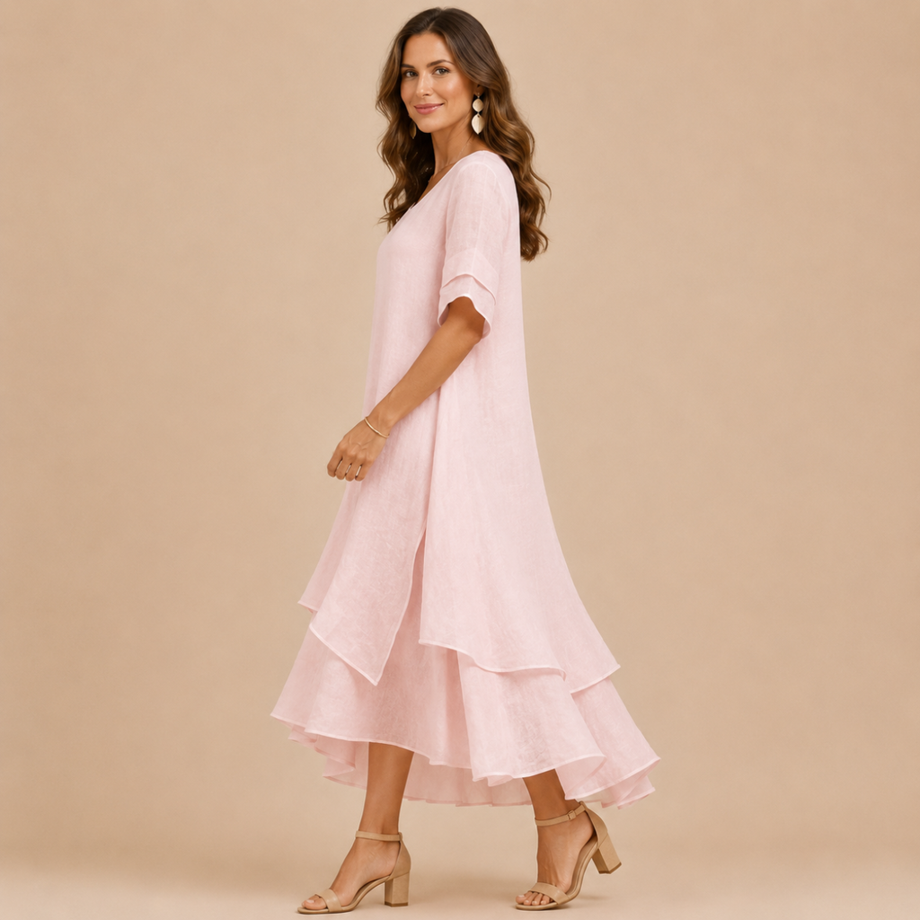Noor Floral-Print Round-Neck Linen Midi Dress in Pink, side view showcasing the flowing layered hem and relaxed silhouette. Designed by Bella Hudson.