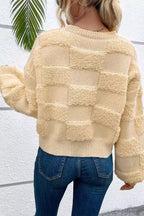 Nora Beige checkered knit sweater with raised textured pattern and ribbed hem, shown from the back