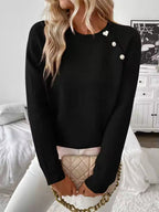 Nora Black knit sweater featuring diagonal button accents, a round neckline, and relaxed fit