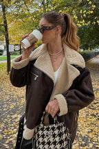 Nora Brown faux shearling aviator jacket with an oversized fit, wide lapel collar, zip detailing, and long sleeves