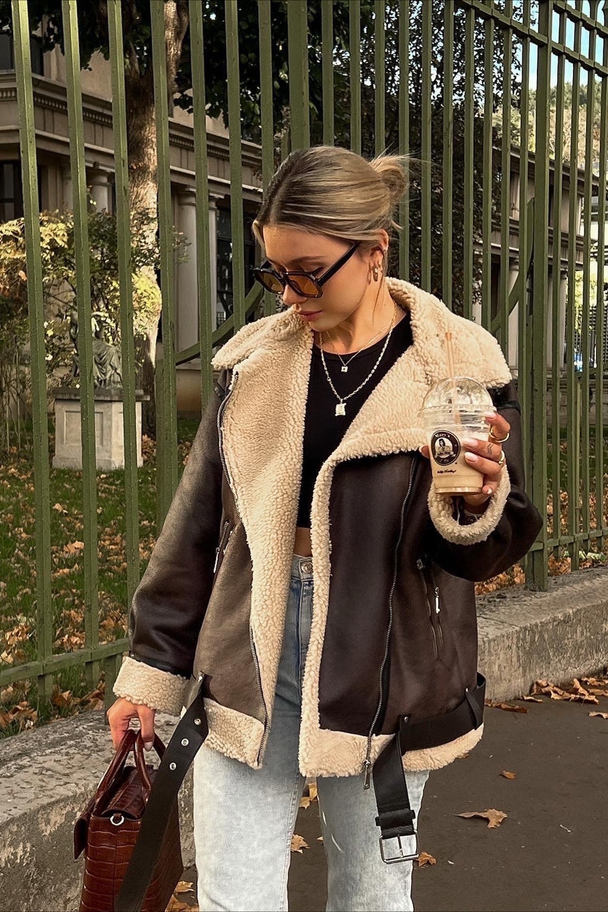 Nora Brown faux shearling aviator jacket shown in a full-body view with a relaxed oversized silhouette and wide lapels