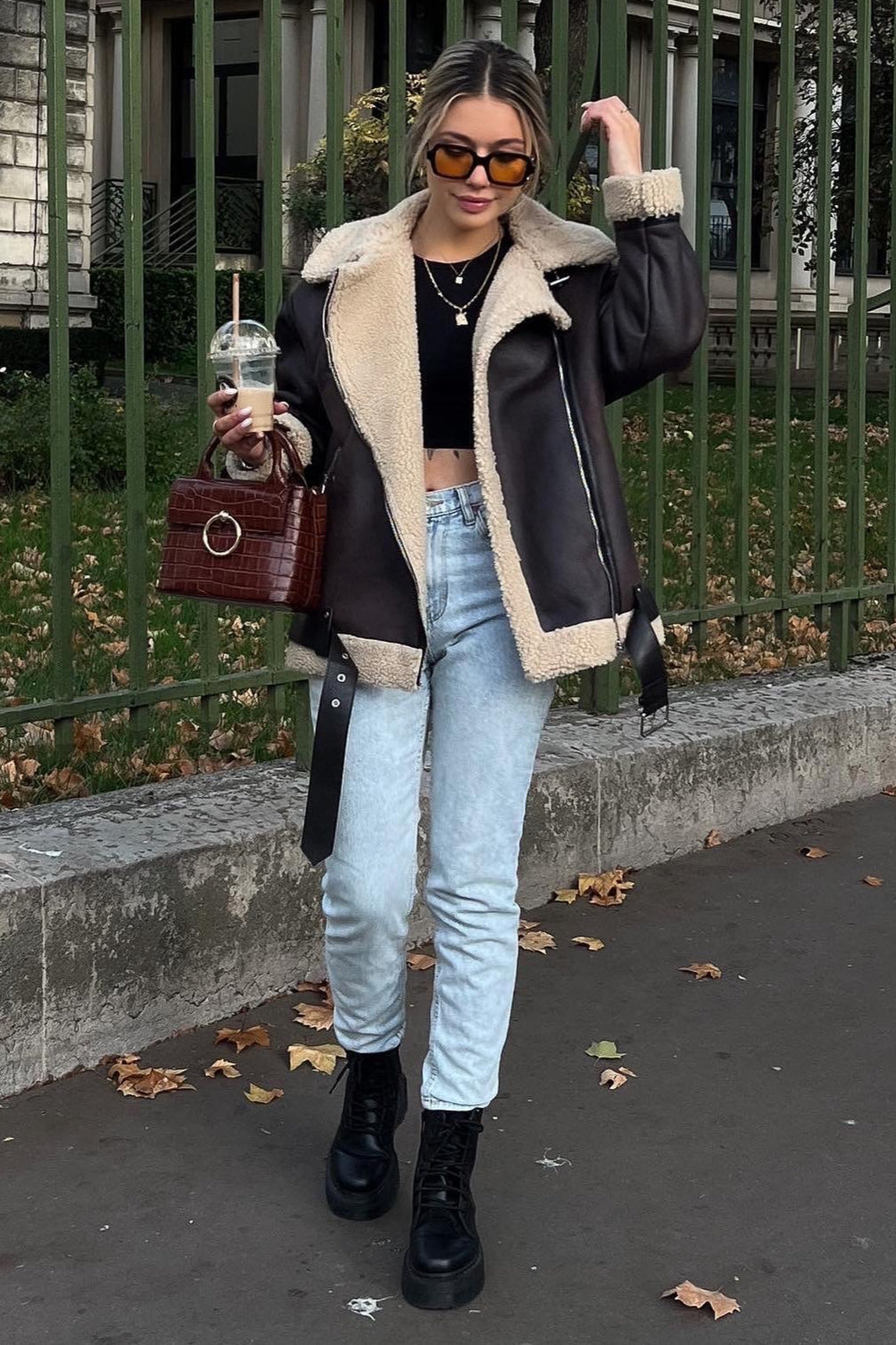 Nora Brown faux shearling aviator jacket styled outdoors with a relaxed fit, wide lapels, and zip details