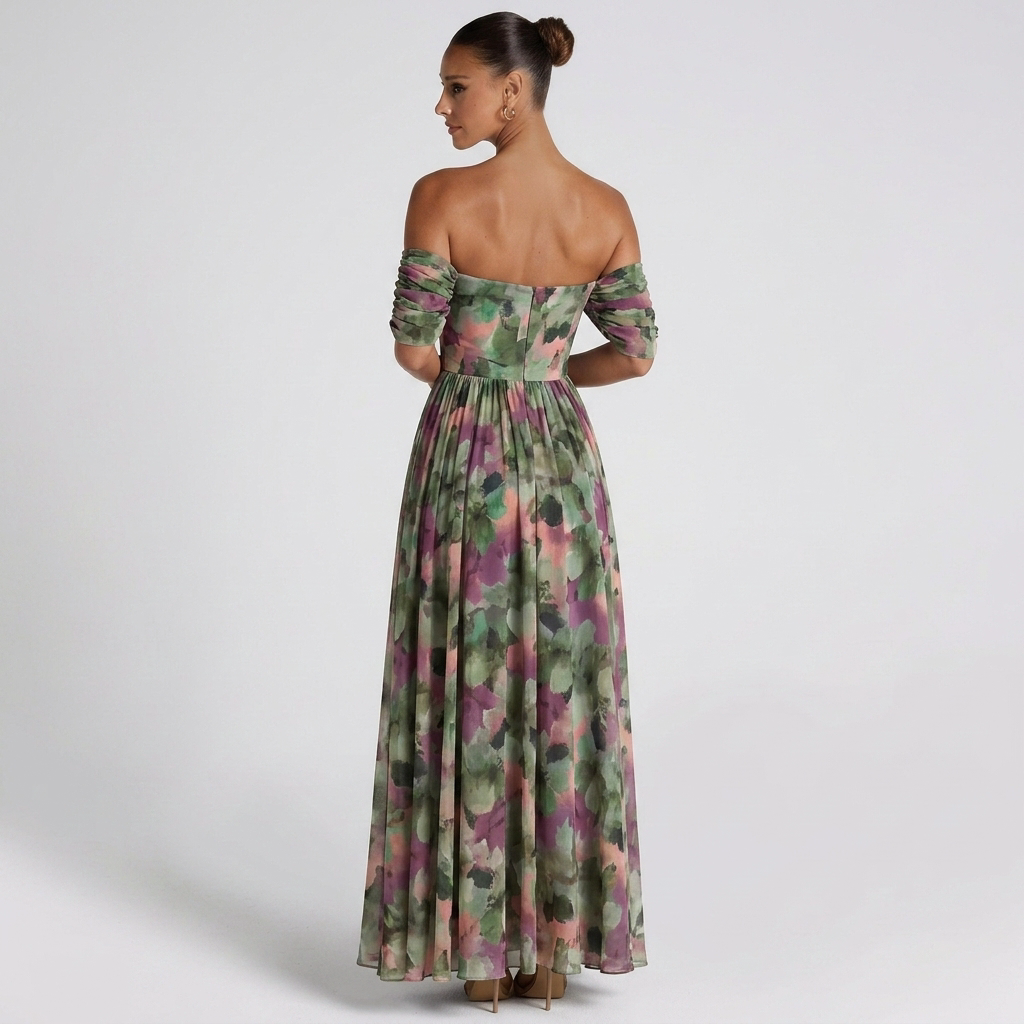 Back view of the Nova Evening Maxi Dress with Off Shoulder and Ruched Waist Style in green floral, highlighting the off-the-shoulder back, flowing maxi skirt, and elegant floral pattern. Designed by Bella Hudson.