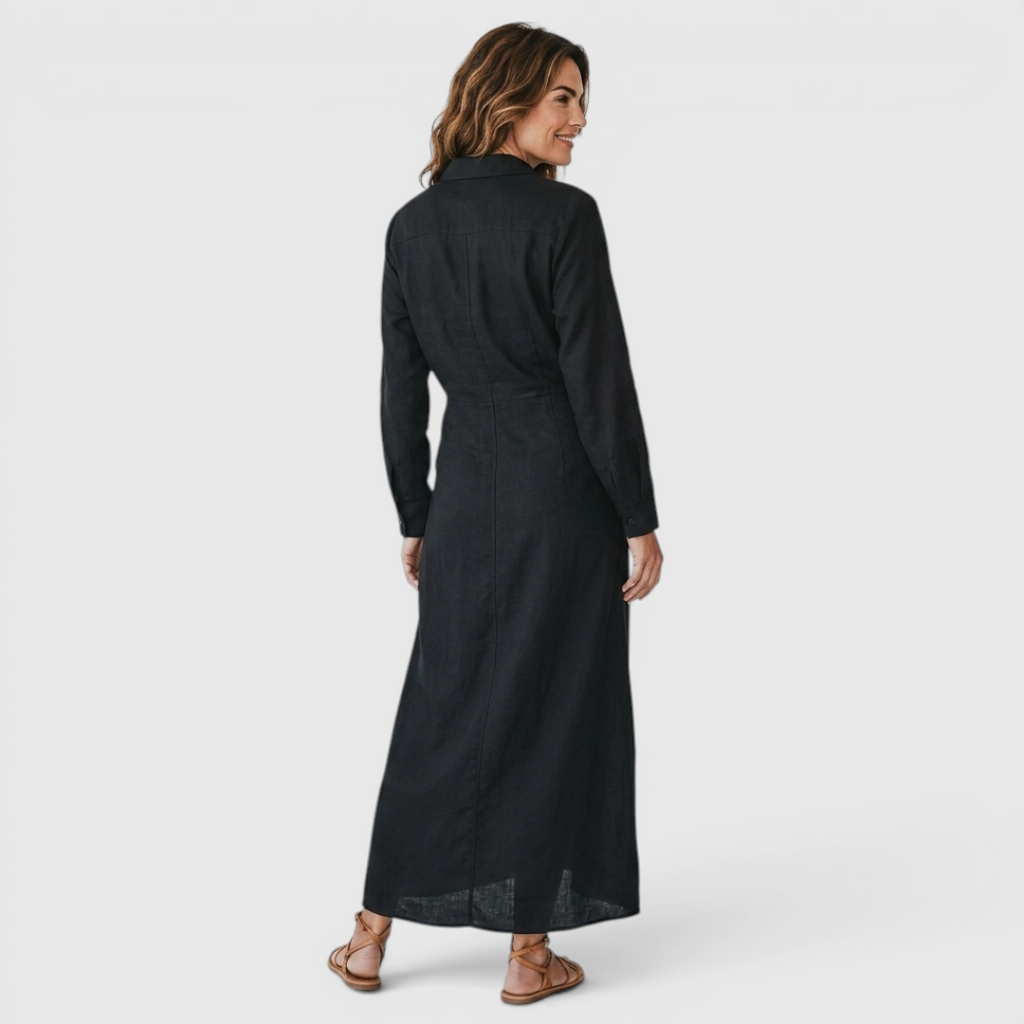 Back view of the Océane Shirt Dress Linen-Cotton Knot-Waist Maxi in black, highlighting the relaxed silhouette, long sleeves, and flowing maxi-length design. Designed by Bella Hudson.