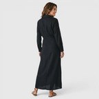 Back view of the Océane Shirt Dress Linen-Cotton Knot-Waist Maxi in black, highlighting the relaxed silhouette, long sleeves, and flowing maxi-length design. Designed by Bella Hudson.