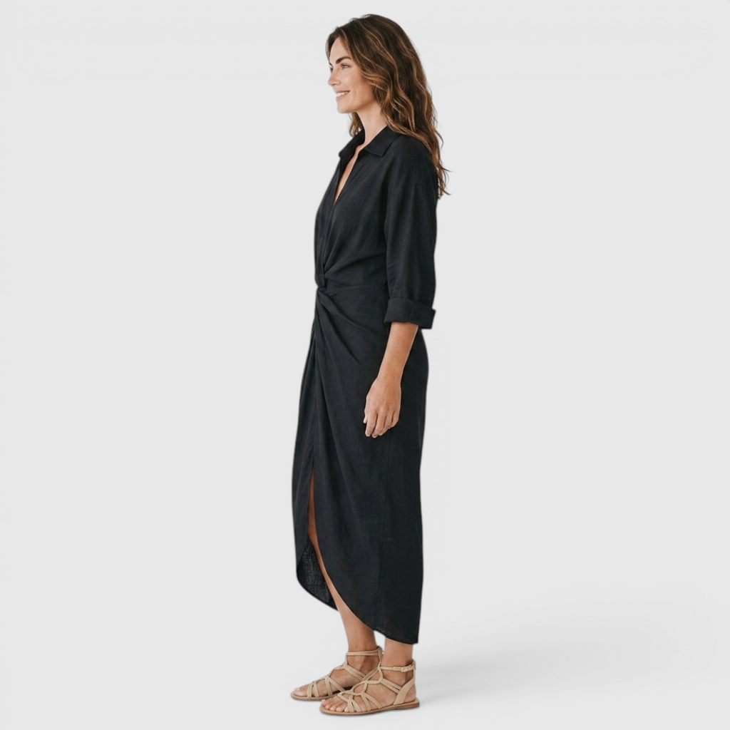 Side view of the Océane Shirt Dress Linen-Cotton Knot-Waist Maxi in black, showcasing the collared neckline, rolled long sleeves, knot-waist detail, and elegant maxi-length silhouette. Designed by Bella Hudson.