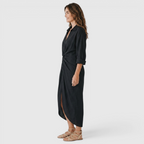 Side view of the Océane Shirt Dress Linen-Cotton Knot-Waist Maxi in black, showcasing the collared neckline, rolled long sleeves, knot-waist detail, and elegant maxi-length silhouette. Designed by Bella Hudson.