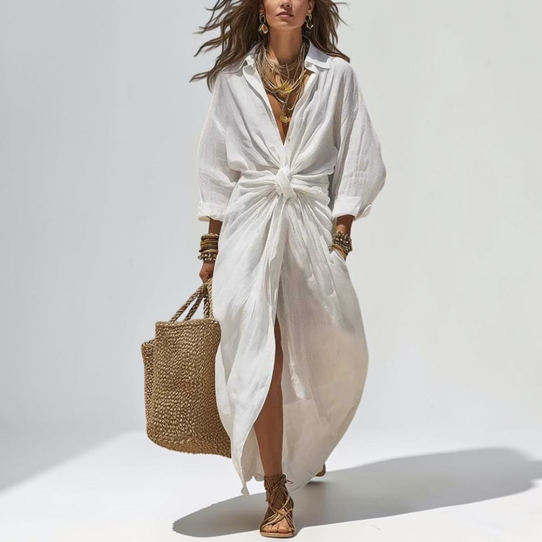 Front view of the Océane Shirt Dress Linen-Cotton Knot-Waist Maxi in white, featuring a collared neckline, button-front closure, knot-waist detail, and a flowing maxi-length silhouette. Designed by Bella Hudson.