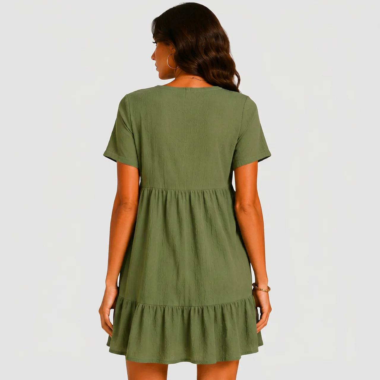 Back view of olive green tiered mini dress with short sleeves by BELLA HUDSON
