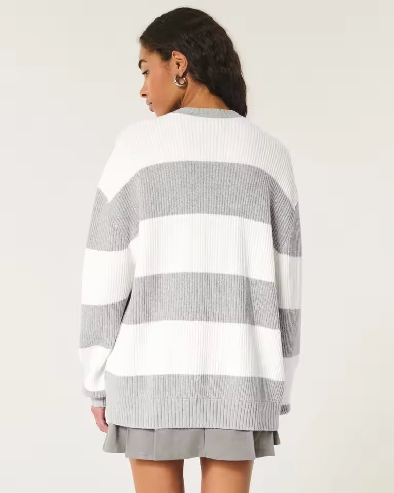 Olivia White oversized striped sweater with wide horizontal stripes, long sleeves, and ribbed hem, shown from the back