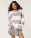 Olivia White striped crewneck sweater with oversized fit, dropped shoulders, and long sleeves, styled with a skirt