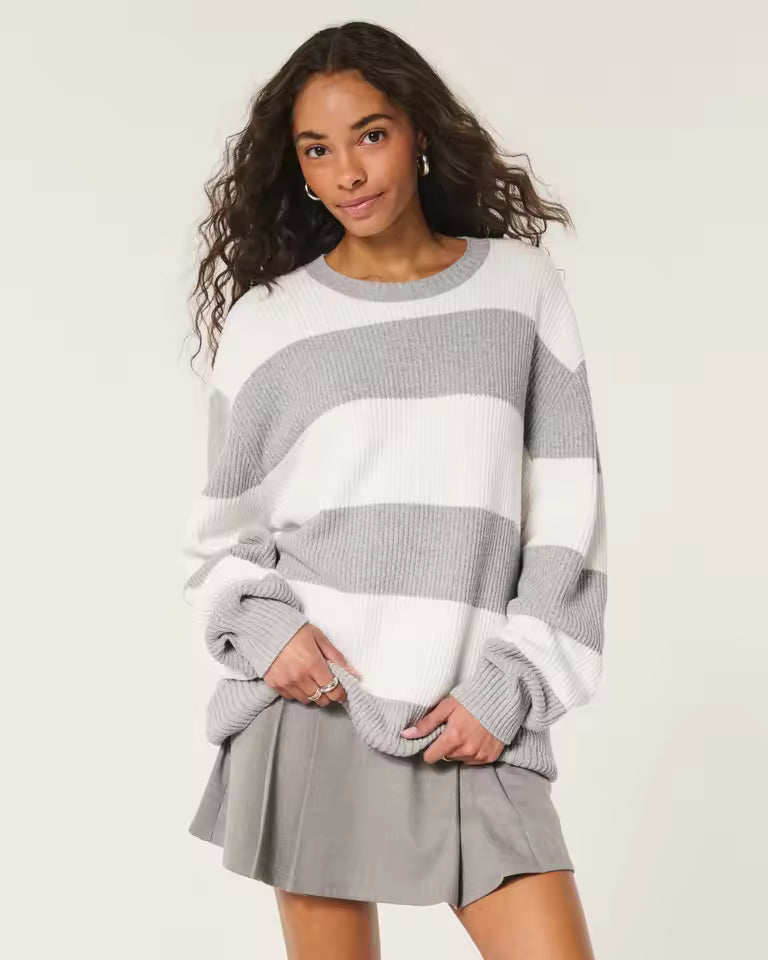 Olivia White striped crewneck sweater with oversized fit, dropped shoulders, and long sleeves, styled with a skirt