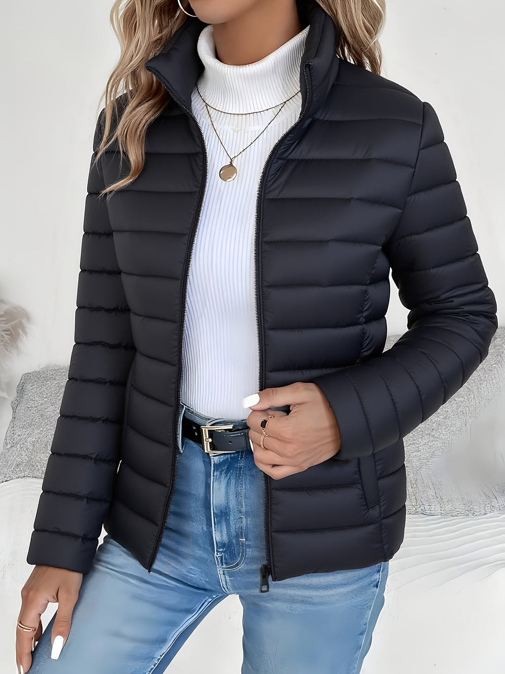 Front view of the Ondine Jacket Puffer Stand-Collar in black, featuring a stand collar, quilted puffer construction, zip-front closure, and a lightweight insulated silhouette. Designed by Bella Hudson.