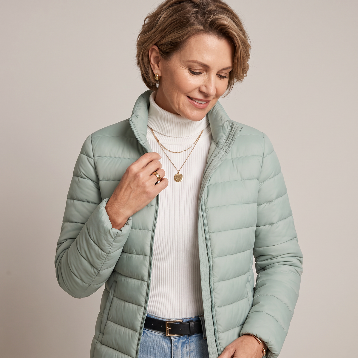 Close-up detail of the Ondine Jacket Puffer Stand-Collar in green, featuring the quilted texture, stand collar, zip-front closure, and lightweight insulated fabric. Designed by Bella Hudson.