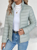 Lifestyle view of the Ondine Jacket Puffer Stand-Collar in green, showcasing the quilted puffer design, stand collar, zip-front closure, and everyday styling. Designed by Bella Hudson.