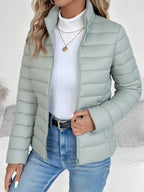 Lifestyle view of the Ondine Jacket Puffer Stand-Collar in green, showcasing the quilted puffer design, stand collar, zip-front closure, and everyday styling. Designed by Bella Hudson.