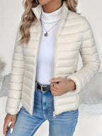Front view of the Ondine Jacket Puffer Stand-Collar in white, featuring a stand collar, quilted puffer construction, zip-front closure, and a lightweight insulated silhouette. Designed by Bella Hudson.