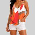 Front view of orange abstract print cami top with chain straps and sleeveless design by BELLA HUDSON