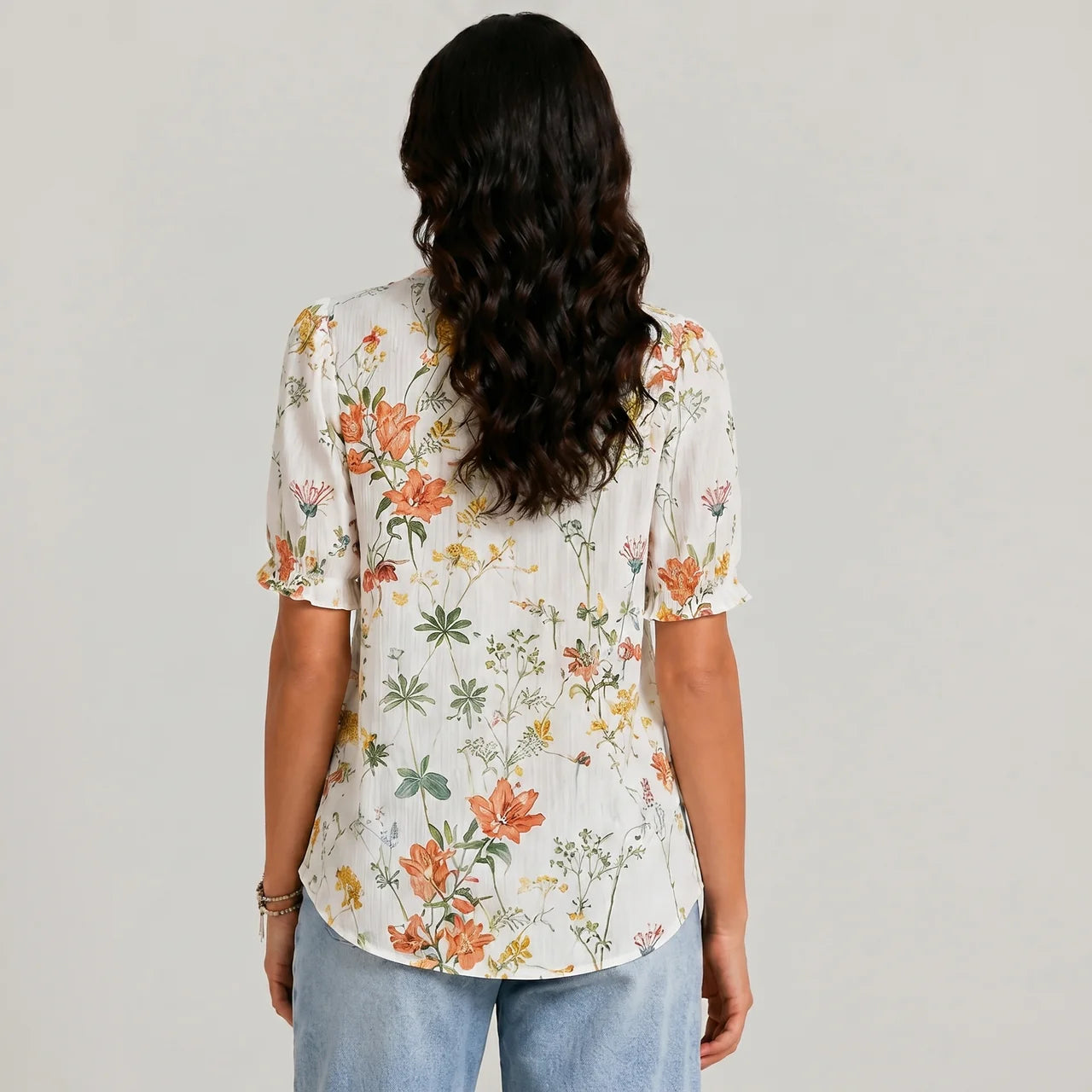 Back view of orange floral button blouse with short sleeves and relaxed fit by BELLA HUDSON