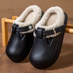 Paige Black mule slippers with rounded closed toes, soft faux-fur lining, decorative buckle straps, and thick soles