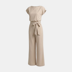 Front view of the Paloma Jumpsuit Wide-Leg Tie-Waist in beige, featuring a round neckline, cap sleeves, self-tie waist belt, and a relaxed wide-leg silhouette. Designed by Bella Hudson.