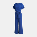 Front view of the Paloma Jumpsuit Wide-Leg Tie-Waist in blue, featuring a round neckline, cap sleeves, self-tie waist, and a relaxed wide-leg fit. Designed by Bella Hudson.