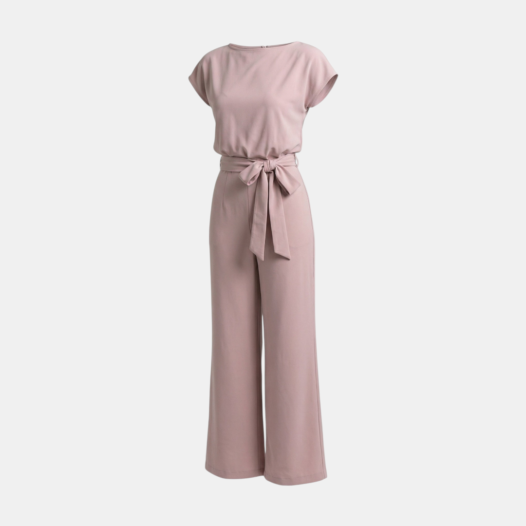 Hanging view of the Paloma Jumpsuit Wide-Leg Tie-Waist in pink, showcasing the round neckline, cap sleeves, tie waist, and flowing wide-leg silhouette. Designed by Bella Hudson.