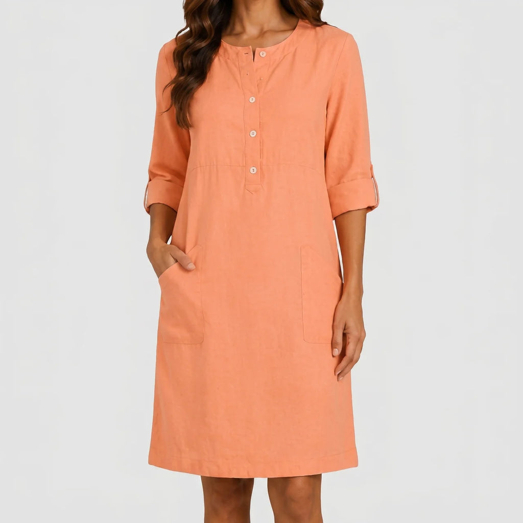 Front view of peach linen midi dress with rolled sleeves and side pockets by BELLA HUDSON