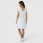 Back view of the Philippa Fit-and-Flare Dress Lace-Trim Puff-Sleeve Striped in white, highlighting the fitted waist, flowing skirt, and graceful knee-length silhouette. Designed by Bella Hudson.