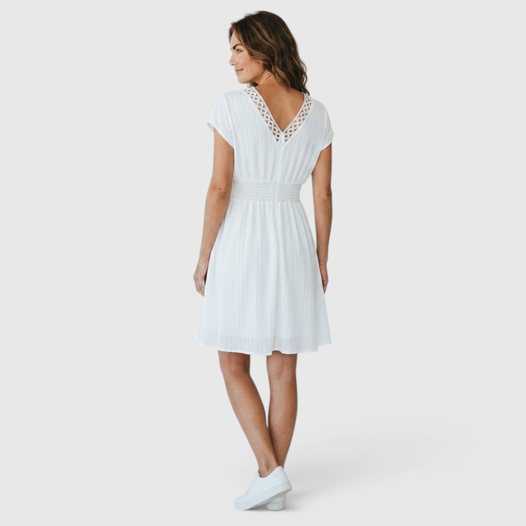Back view of the Philippa Fit-and-Flare Dress Lace-Trim Puff-Sleeve Striped in white, highlighting the fitted waist, flowing skirt, and graceful knee-length silhouette. Designed by Bella Hudson.