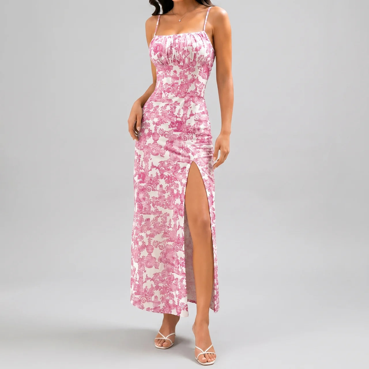 Front view of pink floral slit maxi dress with spaghetti straps and fitted silhouette by BELLA HUDSON