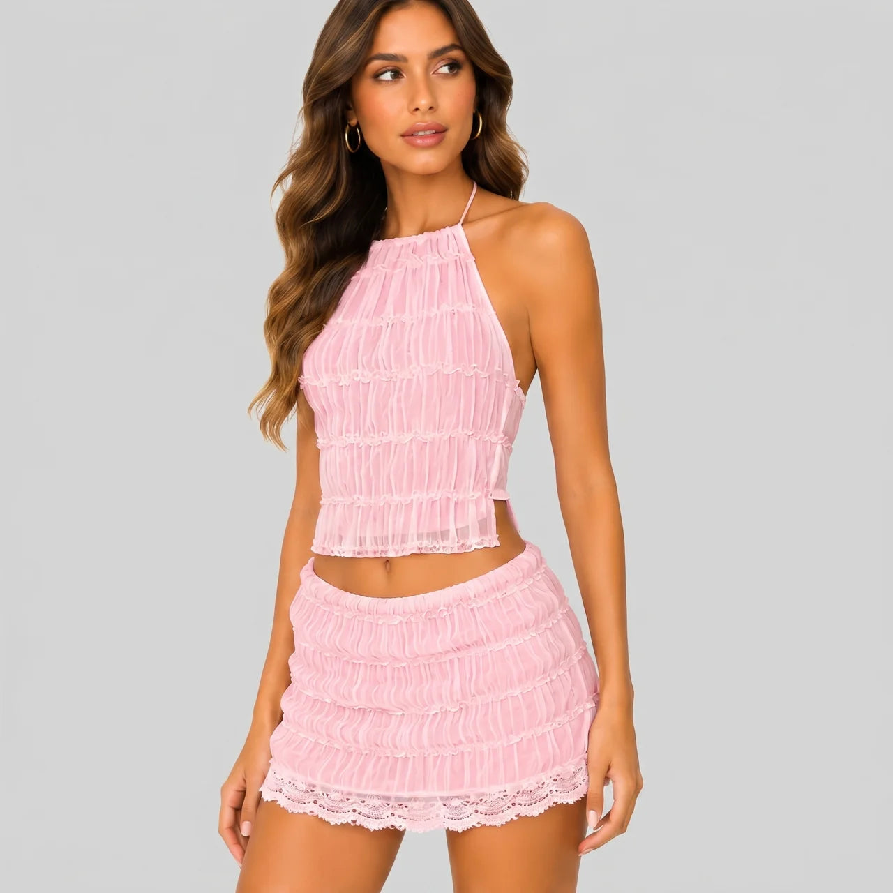 Side view of pink lace crop top and mini skirt set with smocked texture and scalloped hem by BELLA HUDSON
