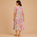 Back view of the Primrose Floral-Print A-Line Midi Dress Lightweight in red, highlighting the colorful floral print, relaxed A-line silhouette, and elegant back design. Designed by Bella Hudson.
