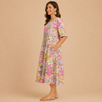 Side view of the Primrose Floral-Print A-Line Midi Dress Lightweight in red, showcasing the flowing A-line silhouette, lightweight fabric, and colorful floral print. Designed by Bella Hudson.