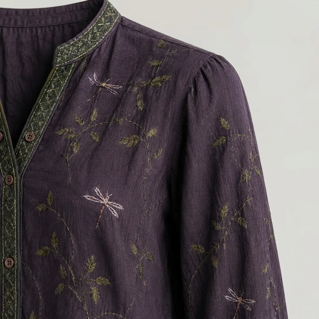 Close-up of purple embroidered boho blouse with green trim detail BELLA HUDSON