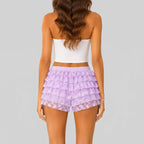 Back view of purple layered ruffle mini shorts with elastic waist by BELLA HUDSON