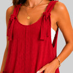 Close-up detail view of red sleeveless short jumpsuit with tie shoulder straps by BELLA HUDSON