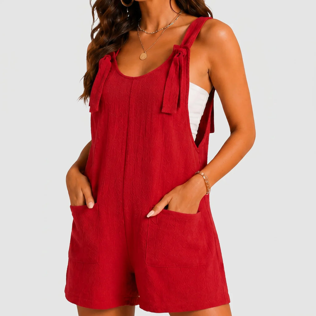 Front view of red sleeveless short jumpsuit with side pockets by BELLA HUDSON