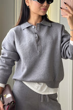 Rhea Gray knit polo lounge set close-up featuring the collared neckline, partial button placket, and relaxed long sleeves