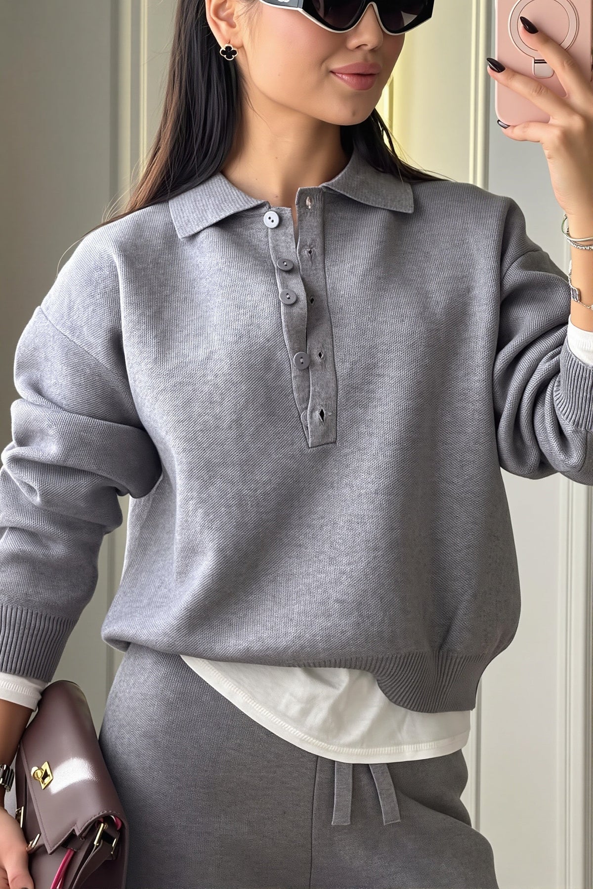 Rhea Gray knit polo lounge set close-up featuring the collared neckline, partial button placket, and relaxed long sleeves