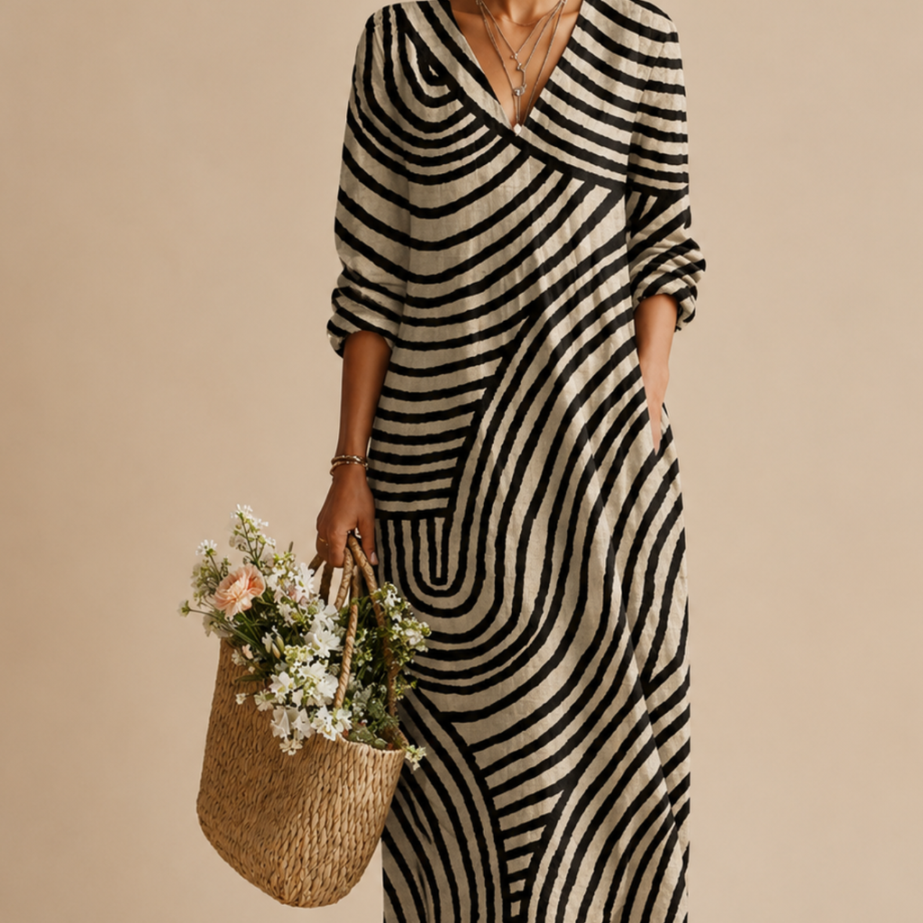 Close-up detail of the Romy Striped Lightweight Vintage Midi Dress highlighting the abstract striped patchwork pattern, V-neckline, lightweight fabric, and relaxed construction. Designed by Bella Hudson.