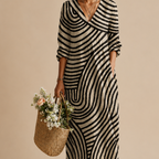 Close-up detail of the Romy Striped Lightweight Vintage Midi Dress highlighting the abstract striped patchwork pattern, V-neckline, lightweight fabric, and relaxed construction. Designed by Bella Hudson.