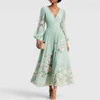 Front view of the Rosalie Midi Dress Floral-Print Chiffon Pleated V-Neck in light green, featuring a V-neckline, long bishop sleeves, pleated chiffon skirt, delicate floral print, and a flowing midi-length silhouette. Designed by Bella Hudson.