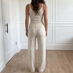 Rosalie White two-piece set shown from the back, with the tank top and relaxed wide-leg pants in a scattered floral print.